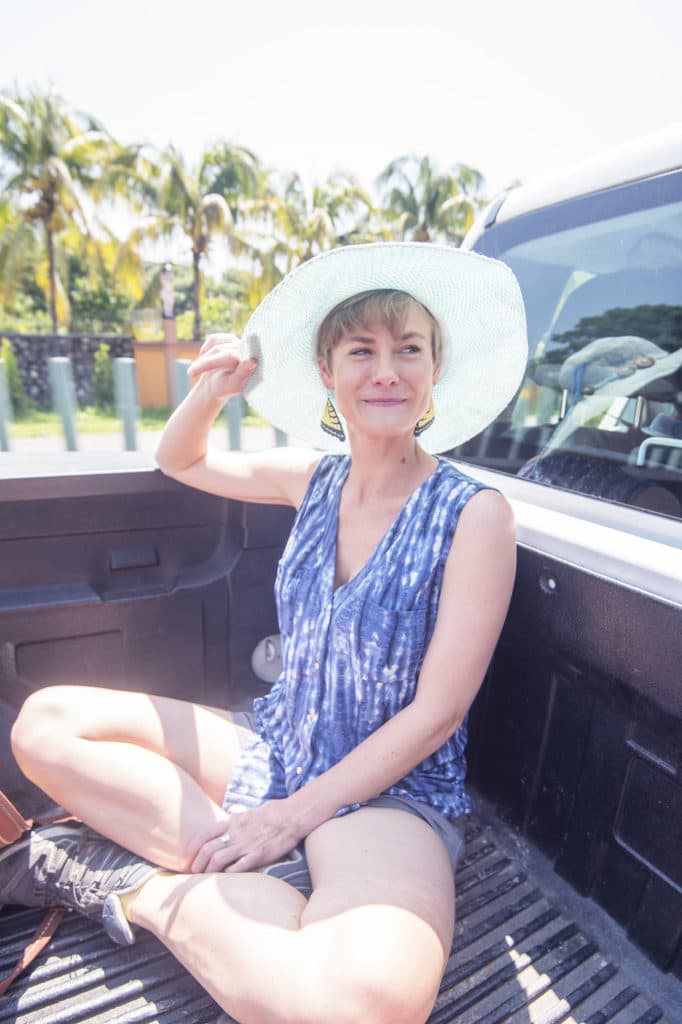 Ava is riding in the back of a pickup truck while on the Chiapas Chocolate Retreats. She is heading into the cacao forest, and is excited to teach women about empowerment through connection to their wildness, to adventure, and to their senses.